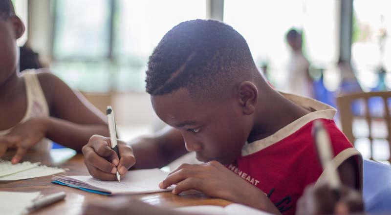 A young boy writing